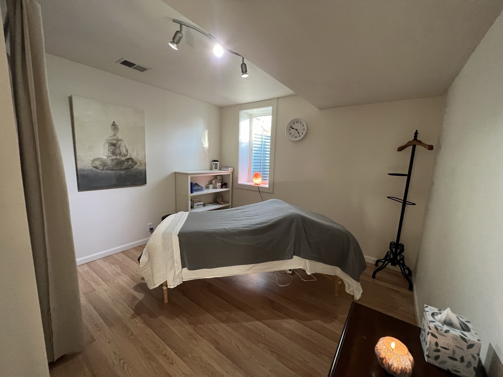 The treatment room at Ananda Natural Medicine, with massage table, salt lamp and Buddha canvas